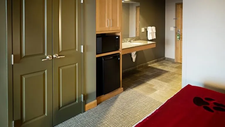 The closet and mini-fridge in the accessible Family Suite (Accessible bathtub)